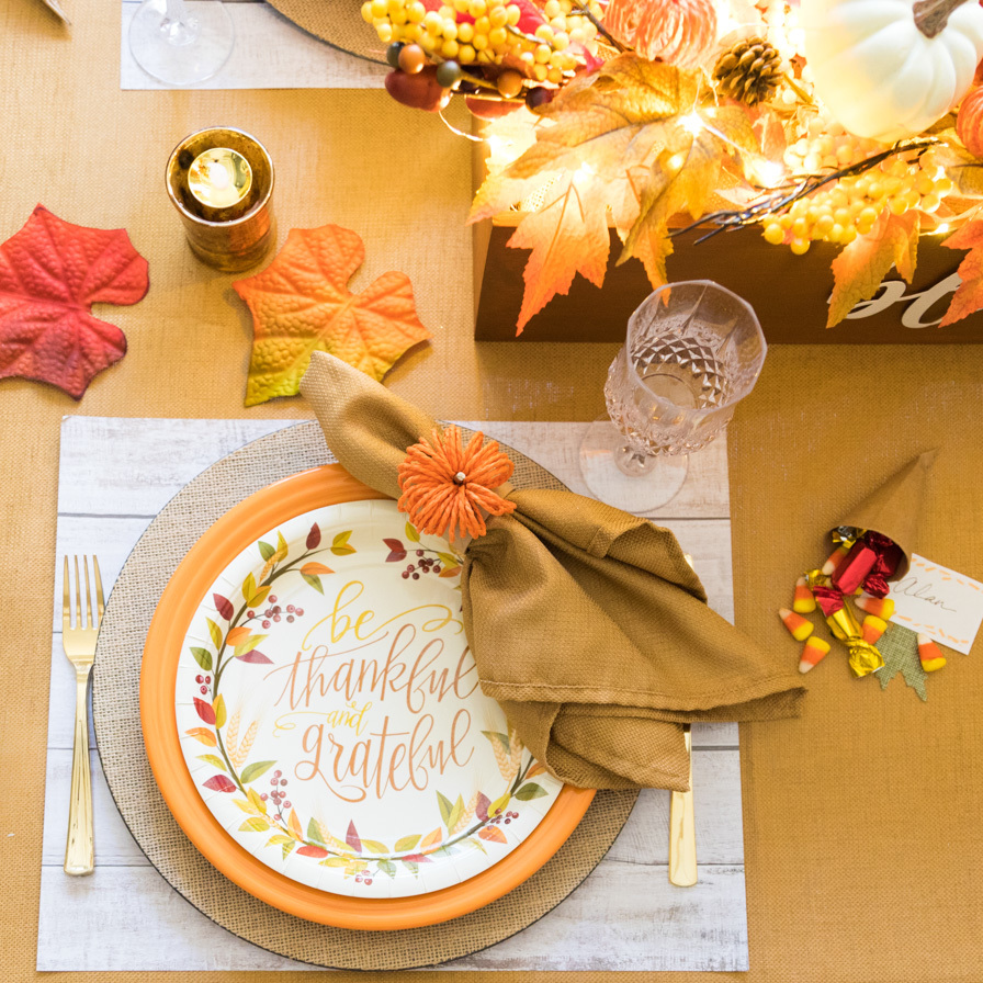image: table setting with fall decor and a plate that says be thankful and grateful